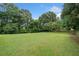 Beautiful backyard featuring a green lawn and mature trees for relaxing and entertaining at 173 Cline Smith Ne Rd, Cartersville, GA 30121