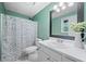 Bathroom featuring a shower-tub, a sink with vanity, and a floral shower curtain at 173 Cline Smith Ne Rd, Cartersville, GA 30121