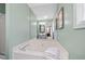 Bright bathroom featuring a soaking tub with a towel and mint green walls, creating a serene atmosphere at 173 Cline Smith Ne Rd, Cartersville, GA 30121