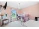 Charming bedroom features a lofted bed, a vanity, and a large window, creating a delightful and functional space at 173 Cline Smith Ne Rd, Cartersville, GA 30121