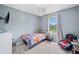 Cozy bedroom features a bed, a window with a view, and a chair, creating a comfortable and inviting atmosphere at 173 Cline Smith Ne Rd, Cartersville, GA 30121