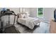 Cozy bedroom featuring a comfortable bed, a large window, and a convenient treadmill at 173 Cline Smith Ne Rd, Cartersville, GA 30121