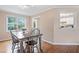Cozy dining room with hardwood floors, a wooden table, and natural light from a large window at 173 Cline Smith Ne Rd, Cartersville, GA 30121
