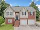 Two-story home featuring a brick and siding exterior, two-car garage, and landscaped front yard at 173 Cline Smith Ne Rd, Cartersville, GA 30121