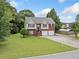 Exterior shot of a charming two-story home on a well-maintained lot with mature trees at 173 Cline Smith Ne Rd, Cartersville, GA 30121