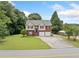 Exterior shot of a charming two-story home on a well-maintained lot with mature trees at 173 Cline Smith Ne Rd, Cartersville, GA 30121