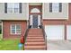 Close up of a home's brick stairs leading up to the front door and two-car garage at 173 Cline Smith Ne Rd, Cartersville, GA 30121