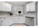 Spacious kitchen with white cabinets, a stainless steel dishwasher, and a double sink at 173 Cline Smith Ne Rd, Cartersville, GA 30121