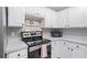 Modern kitchen with stainless steel appliances, light countertops, and updated cabinetry at 173 Cline Smith Ne Rd, Cartersville, GA 30121