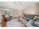 Inviting living room showcasing a plush gray sectional sofa, leather recliner, and hardwood floors at 173 Cline Smith Ne Rd, Cartersville, GA 30121