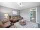 Cozy living room with a large sofa, a coffee table, and a window, perfect for relaxation and socializing at 173 Cline Smith Ne Rd, Cartersville, GA 30121
