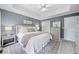 Comfortable main bedroom featuring a tray ceiling, a large bed, and a neutral color scheme at 173 Cline Smith Ne Rd, Cartersville, GA 30121
