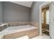 Bright bathroom featuring a large tub with mosaic tile surround at 2056 Plantation Rd, Lawrenceville, GA 30044