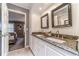 Elegant bathroom with double vanity, granite countertops, and modern fixtures, creating a luxurious space for grooming at 2056 Plantation Rd, Lawrenceville, GA 30044