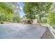 Community clubhouse and parking, surrounded by lush trees and landscaping at 2056 Plantation Rd, Lawrenceville, GA 30044