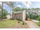 Traditional brick home with a well-manicured lawn and a long driveway at 2056 Plantation Rd, Lawrenceville, GA 30044