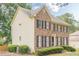 Charming brick home with black shutters surrounded by lush greenery and landscaping at 2056 Plantation Rd, Lawrenceville, GA 30044
