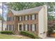 Charming brick home with classic black shutters and a well-maintained front yard at 2056 Plantation Rd, Lawrenceville, GA 30044