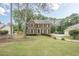 Beautiful two-story brick home with a well-manicured lawn and mature trees at 2056 Plantation Rd, Lawrenceville, GA 30044