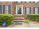 Inviting front porch with decorative pots, brick steps, and an ADT security system for added safety at 2056 Plantation Rd, Lawrenceville, GA 30044