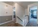 Upstairs hallway with two-tone paint and carpeted floor provides access to multiple rooms, highlighting the home's layout at 2056 Plantation Rd, Lawrenceville, GA 30044