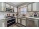 Modern kitchen featuring stainless steel appliances, sleek countertops, and ample lighting for an efficient cooking space at 2056 Plantation Rd, Lawrenceville, GA 30044