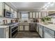 Well-equipped kitchen with stainless steel appliances, marble countertops, and ample cabinet space for cooking convenience at 2056 Plantation Rd, Lawrenceville, GA 30044