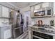 Functional kitchen with stainless steel refrigerator, gas range, and ample counter space, perfect for culinary creations at 2056 Plantation Rd, Lawrenceville, GA 30044