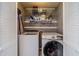 Laundry closet with a modern washer and dryer, and storage shelving for laundry products at 2056 Plantation Rd, Lawrenceville, GA 30044