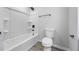 Clean, well-lit bathroom featuring a tub/shower with updated fixtures, and gray tone flooring at 2246 Hightrail Ct, Lithonia, GA 30058