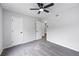 Spacious bedroom with carpet flooring, a ceiling fan, neutral walls, and a hallway doorway at 2246 Hightrail Ct, Lithonia, GA 30058