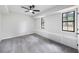 Spacious bedroom with carpet flooring, a ceiling fan, and natural light from the two windows at 2246 Hightrail Ct, Lithonia, GA 30058