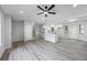 Open-concept living area with gray flooring, light walls, and new kitchen with stainless steel appliances and a backyard door at 2246 Hightrail Ct, Lithonia, GA 30058