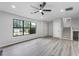 Bright living room features new gray flooring, fresh walls, and lots of natural light from the surrounding windows at 2246 Hightrail Ct, Lithonia, GA 30058