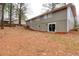 Back exterior of home, showcasing walk-out basement door and multi-level yard at 2279 Hickory Grove Nw Rd, Acworth, GA 30101