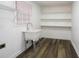 Clean laundry room with a utility sink, shelves and a window at 2279 Hickory Grove Nw Rd, Acworth, GA 30101