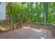 Large wooden deck with railings, surrounded by lush greenery and trees, offering a private outdoor retreat at 630 Pennylake Ct, Stone Mountain, GA 30087
