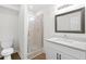 Bathroom featuring a shower and a single sink vanity at 630 Pennylake Ct, Stone Mountain, GA 30087