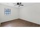 This bedroom features a ceiling fan and a window offering natural light at 630 Pennylake Ct, Stone Mountain, GA 30087