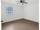 This bedroom features a ceiling fan and a window offering natural light at 630 Pennylake Ct, Stone Mountain, GA 30087