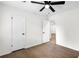 This bedroom offers hardwood floors and white walls with two doors leading to other rooms at 630 Pennylake Ct, Stone Mountain, GA 30087