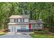 Charming two-story home featuring a welcoming porch and a vibrant red front door at 630 Pennylake Ct, Stone Mountain, GA 30087