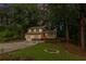 A charming two-story home with a lovely front lawn at dusk at 630 Pennylake Ct, Stone Mountain, GA 30087