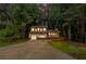 Charming two-story home boasts a red front door, a front porch, and lush, mature trees at 630 Pennylake Ct, Stone Mountain, GA 30087