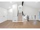 Home foyer featuring hardwood floors and a modern staircase at 630 Pennylake Ct, Stone Mountain, GA 30087