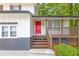 Close-up showcasing the bright red front door and inviting porch of this home at 630 Pennylake Ct, Stone Mountain, GA 30087
