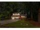 Charming home with a red door, covered porch, and a spacious front yard surrounded by mature trees at 630 Pennylake Ct, Stone Mountain, GA 30087