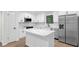 Modern kitchen featuring white cabinetry, quartz countertops, and stainless steel appliances at 630 Pennylake Ct, Stone Mountain, GA 30087