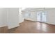 Bright living area featuring hardwood floors, dual windows with blinds, and glass doors to the exterior at 630 Pennylake Ct, Stone Mountain, GA 30087
