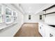 Hardwood floored bonus room featuring wet bar with white cabinetry, shelving, and stainless faucet at 630 Pennylake Ct, Stone Mountain, GA 30087